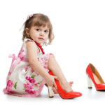 little-girl-trying-on-mummys-shoes