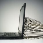 Laptop and newspaper concept for internet and electronic online